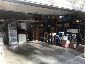 A garage filled with packed moving boxes and wrapped items, ready for transport by Emerald Moving & Storage, Inc. in Eugene, OR.