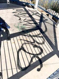 A gazebo floor covered with graffiti before cleaning by EB Restorations & Cleaning Services in Sparks, NV