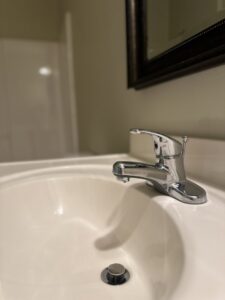 A gleaming bathroom sink and polished faucet, demonstrating the detailed cleaning services of Sudz Up Cleaning Company in Columbia, MO.