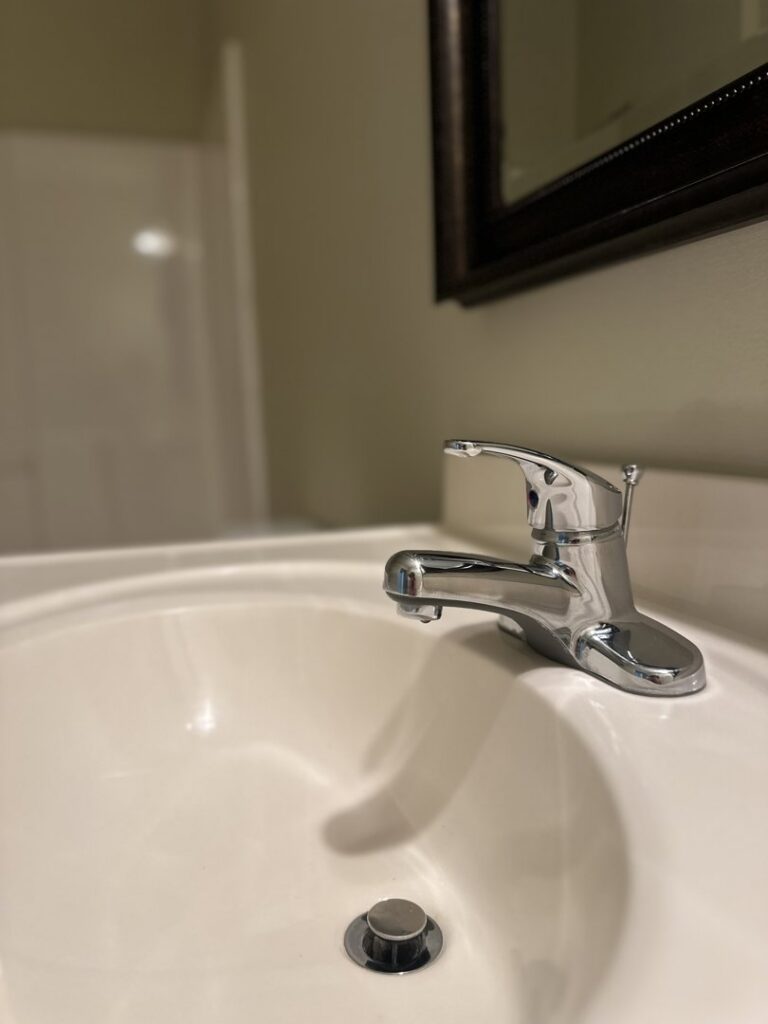 A gleaming bathroom sink and polished faucet, demonstrating the detailed cleaning services of Sudz Up Cleaning Company in Columbia, MO.
