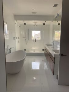 A gleaming modern bathroom with a freestanding tub and large shower, showcasing the cleaning expertise of Simply Clean Jax in Jacksonville, FL.