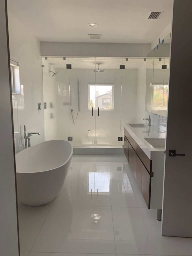 A gleaming modern bathroom with a freestanding tub and large shower, showcasing the cleaning expertise of Simply Clean Jax in Jacksonville, FL.
