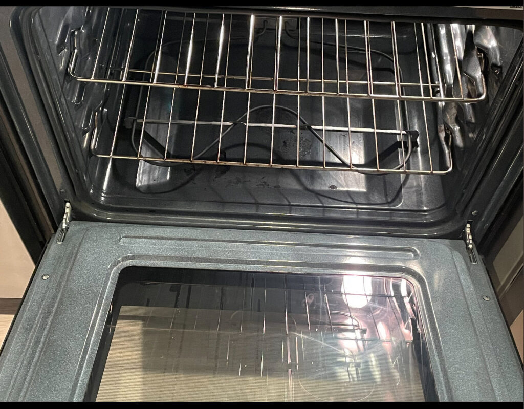A gleaming clean oven interior with racks, highlighting the deep cleaning services of Merriweather Cleaning and Laundry in Vancouver, WA.