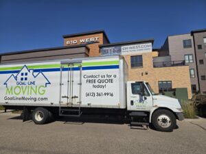 A Goal Line Moving truck parked in front of an apartment building in Maple Grove, MN.