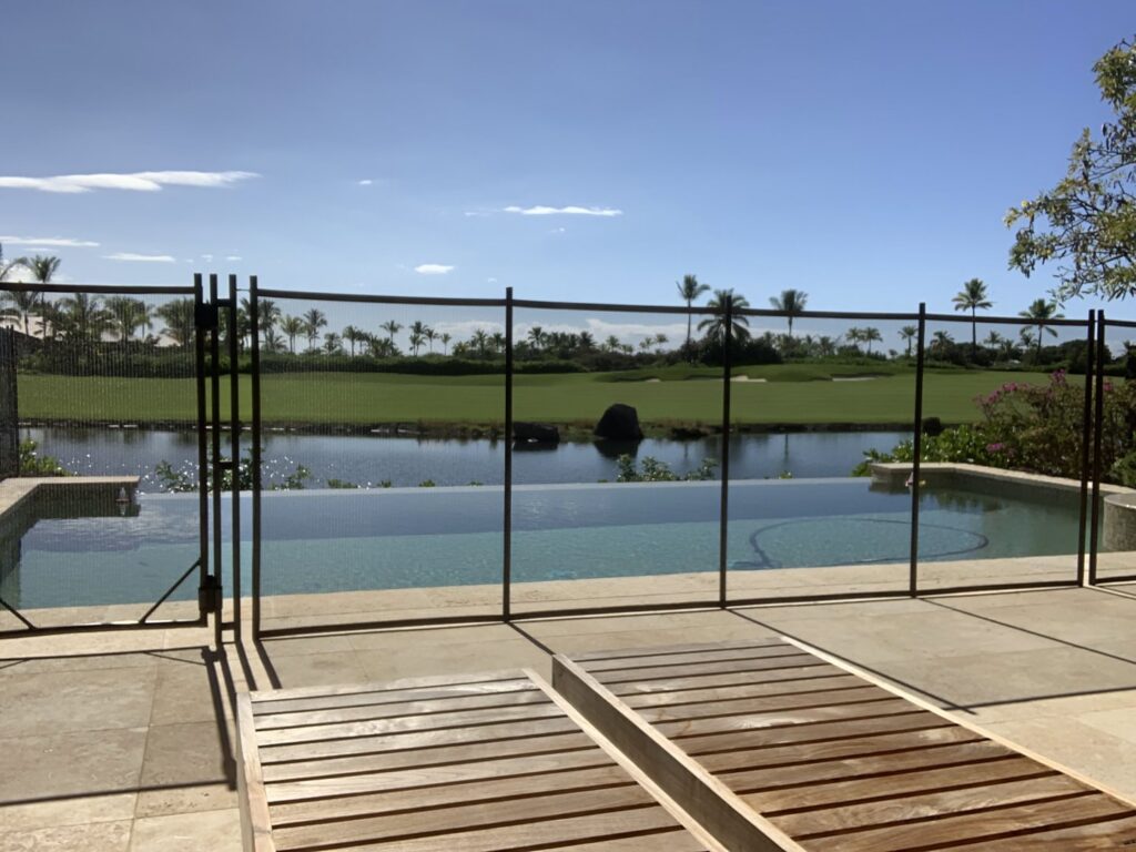 A golf course pool fence installation by Guardian Pool Fence Systems of Hawaii, securing an infinity pool in Honolulu, HI.