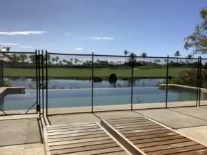 A golf course pool fence installation by Guardian Pool Fence Systems of Hawaii, securing an infinity pool in Honolulu, HI.