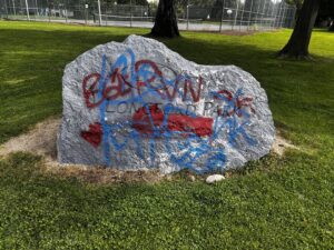 A large park rock covered in graffiti before cleaning by EB Restorations & Cleaning Services in Sparks, NV