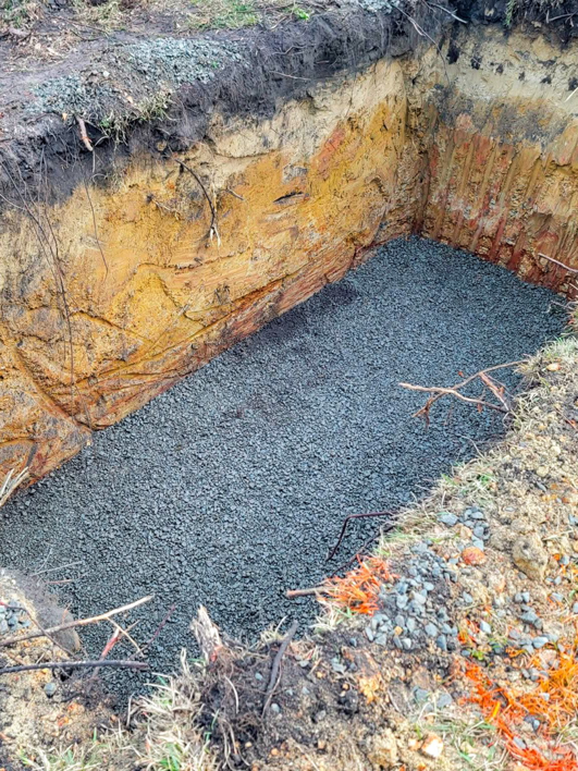 A gravel-filled excavation pit for drainage or foundation work by Gilbert + Lee Construction in Summerville, SC.