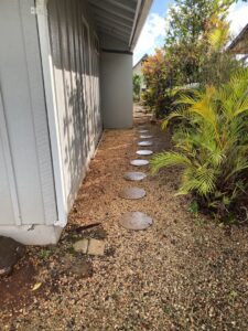 A neat gravel path with round stepping stones and surrounding plants, maintained by LTN Yard Services LLC in Kaneohe, HI.
