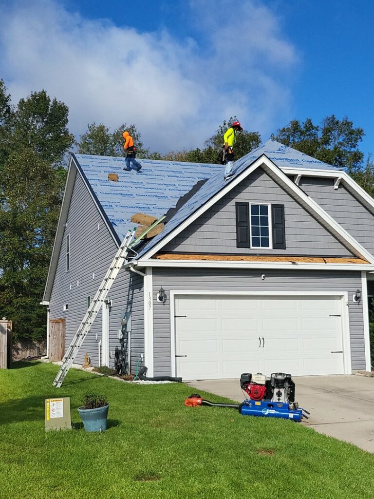 A house featuring new gray horizontal siding and a recently completed roof by Powell Roofing in Ladson, SC.