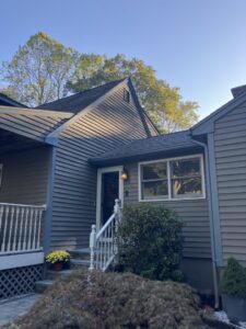 A residential home showcasing new gray horizontal siding installed by DL Roofing and Siding in New Haven, CT