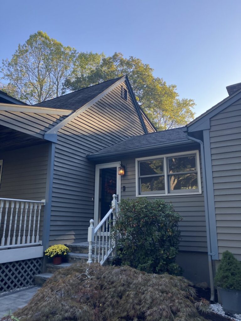 A residential home showcasing new gray horizontal siding installed by DL Roofing and Siding in New Haven, CT