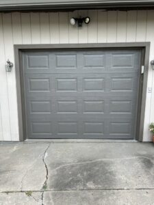 A newly installed gray residential garage door by Woodwards Overhead Door Co. in Topeka, KS