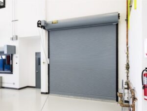 A gray rolling steel commercial garage door installed indoors by Wayne Dalton Sales & Service of Quad Cities in Davenport, IA.