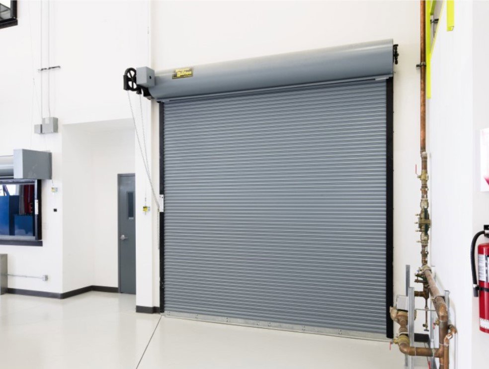 A gray rolling steel commercial garage door installed indoors by Wayne Dalton Sales & Service of Quad Cities in Davenport, IA.