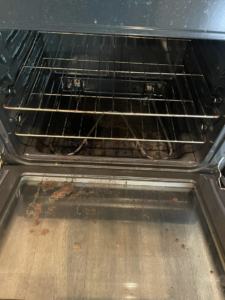 A greasy and dirty oven interior before professional deep cleaning by VM Residential cleaning LLC in Baton Rouge, LA.