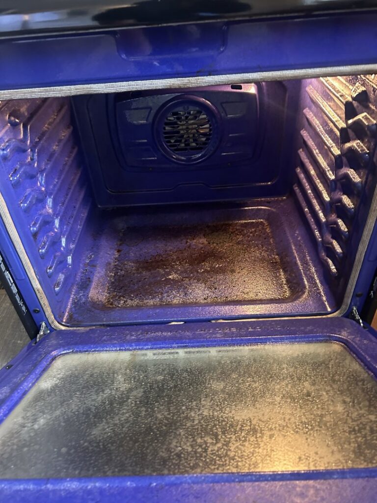 A greasy oven interior with burnt-on residue, ready for a deep clean by Wilkie Wonders Cleaning in Akron, OH.