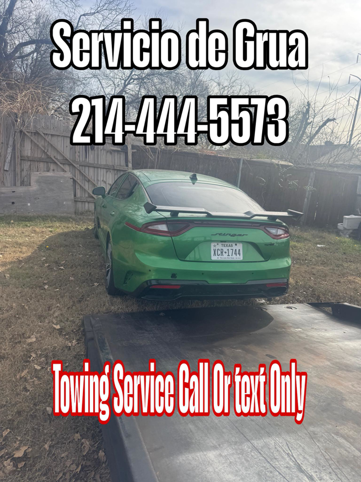 A green car being transported on a flatbed tow truck by Towing Near Me 247 LLC Dallas in Dallas, TX.