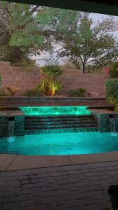 A swimming pool with green, murky water, indicating the need for professional cleaning services from Aloha Pool Cleaning LLC in Las Vegas, NV.