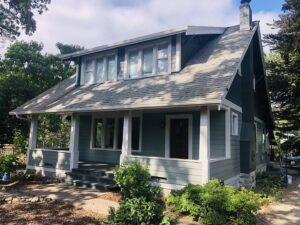 A house featuring new green siding and stone accents, a project by Preferred Exteriors in Roswell, GA