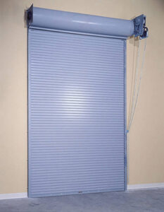A grey rolling steel garage door, a product offered by Vertical Door Solutions in Sheridan, WY
