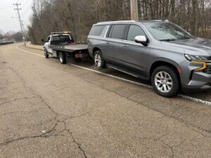A grey SUV being loaded onto a flatbed tow truck, showing towing services by Swift Response Road Services, LLC in Memphis, TN.