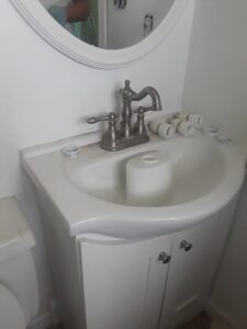 A grimy bathroom sink and faucet before professional cleaning by Ady's Housekeeping in Yakima, WA
