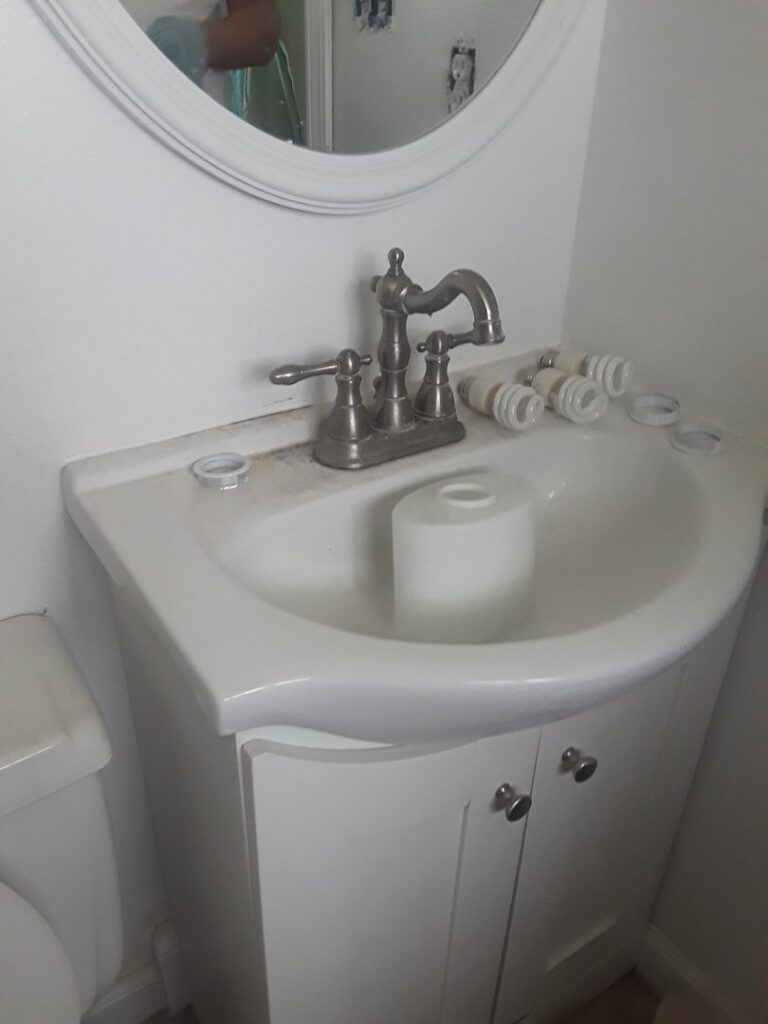 A grimy bathroom sink and faucet before professional cleaning by Ady's Housekeeping in Yakima, WA