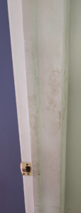 A grimy door frame showing dirt and smudges before a cleaning service from Creativity Cleaning LLC in Detroit, MI.