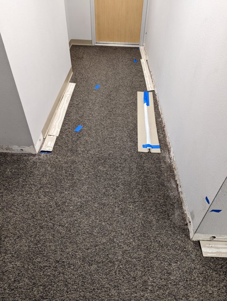 Hallway with baseboards removed and lower walls prepped for water damage repair by Restoration Services Hawaii - RestHi in Honolulu, HI.