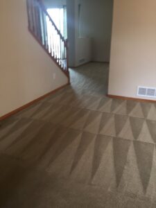 Hallway carpet cleaning in progress, showing the clear difference between cleaned and uncleaned areas by Happy Client Cleaning Services in Fort Collins, CO.