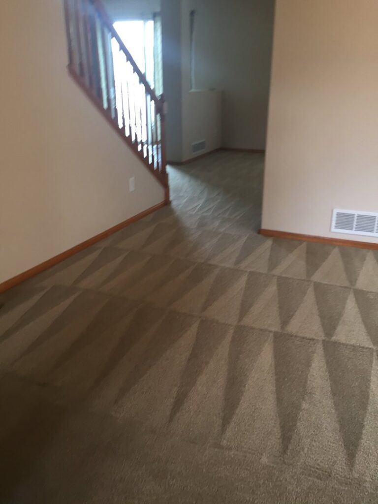 Hallway carpet cleaning in progress, showing the clear difference between cleaned and uncleaned areas by Happy Client Cleaning Services in Fort Collins, CO.