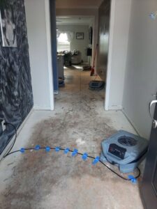 Hallway with water damage drying equipment, including an air mover, set up by Carolina Pro Restoration LLC in Fort Mill, SC.