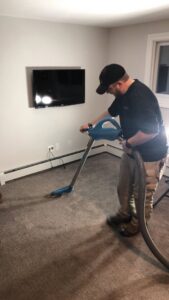 Multiple air movers and dehumidifiers drying a carpeted hallway after water damage by Restoration 1 of Birmingham in Pelham, AL.