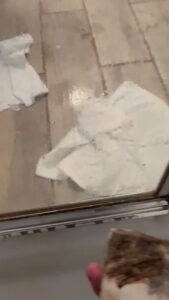 A hand actively wiping a surface with paper towels, demonstrating a cleaning task by AG Simply Clean in Concord, NC.