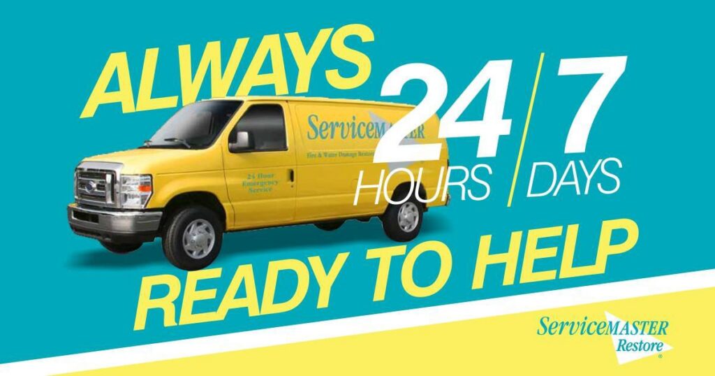 Two ServiceMaster of Lawton house cleaners performing hardwood floor cleaning in a living room in Lawton, OK.