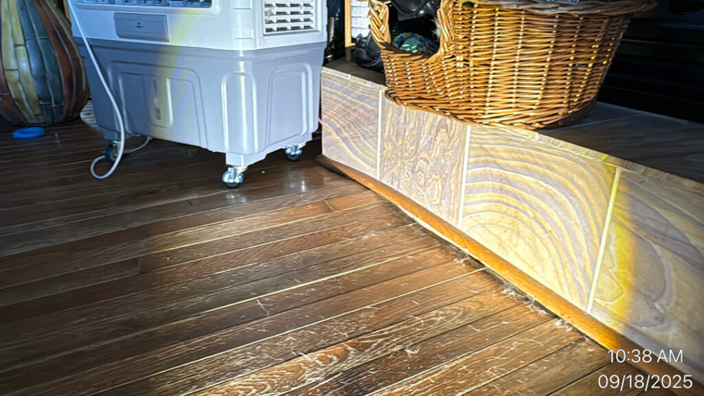 A room with hardwood floors and a large dehumidifier actively drying the area after water damage in Syracuse, UT by Utah Disaster Specialists.