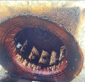A heavily greased and dirty exhaust fan interior before deep cleaning by Bernal Cleaning LLC in Overland Park, KS.