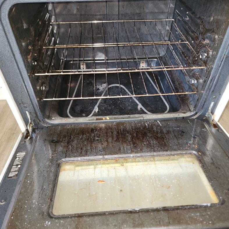 A heavily soiled oven interior, illustrating the deep cleaning services offered by Christina's Tidy Homes in Canton, OH.