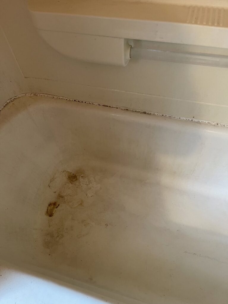 A heavily stained bathtub with significant residue and dirt before deep cleaning by Cinderellas Cleaning in Cerritos, CA