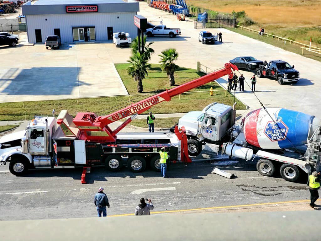 A CC Wrecker Service rotator truck performing a heavy-duty recovery of an overturned cement mixer in Corpus Christi, TX.