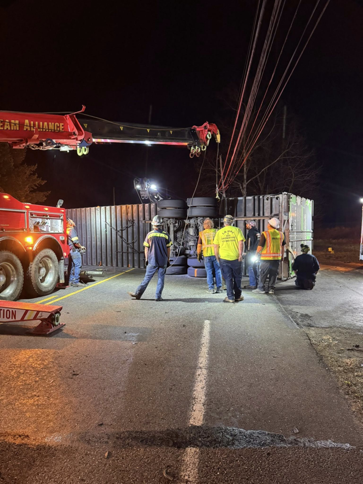 Alliance Towing performing heavy-duty recovery on an overturned semi-trailer at night in Lancaster, PA.