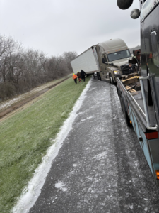 Archie's Towing Service performing a heavy-duty semi-truck recovery operation on an icy road at 105 Daniel Street, Unknown City, US.