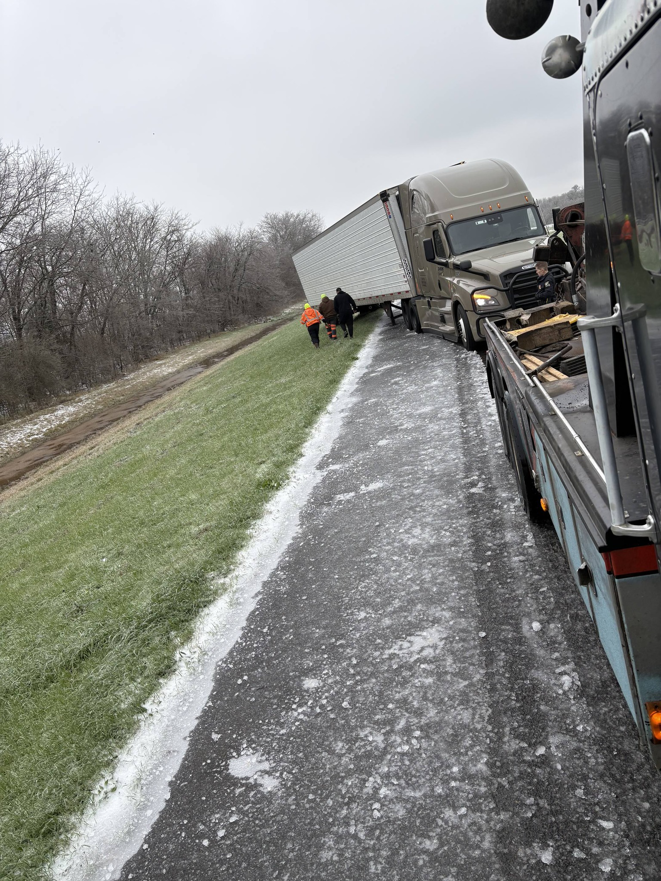 Archie's Towing Service performing a heavy-duty semi-truck recovery operation on an icy road at 105 Daniel Street, Unknown City, US.