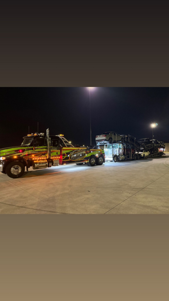 Heavy-duty tow truck hauling multiple vehicles at night for County Towing & Recovery LLC in West Columbia, SC.