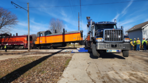 Elmquist Towing & Recovery performing heavy-duty recovery, lifting a train locomotive off tracks in Ames, IA.