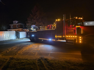 A heavy-duty tow truck assisting with a truck recovery operation at night for Alliance Towing in Lancaster, PA.