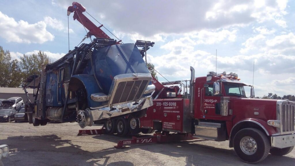 A heavy-duty wrecker from Tally's Towing and Recovery lifting the front of a semi-truck in Owensboro, KY.
