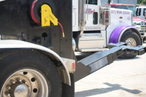 Rear view of a heavy-duty wrecker tow truck with its boom extended, ready for service at Dixon's Towing & Roadside Assistance in Dallas, TX.