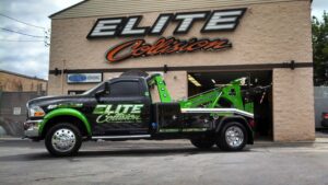 A heavy-duty wrecker tow truck from Elite Collision parked outside, providing towing services in Pittsburgh, PA.